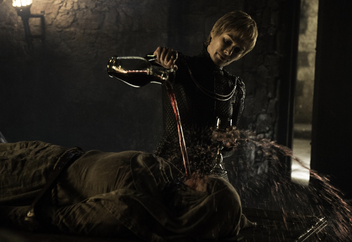 Lena Headey pouring liquid onto Hannah Waddingham in a Game of Thrones episode.