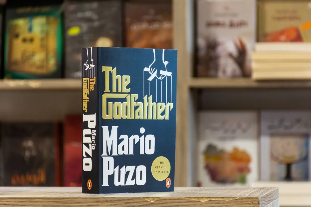 The Godfather by Mario Puzo on a shelf in a bookstore