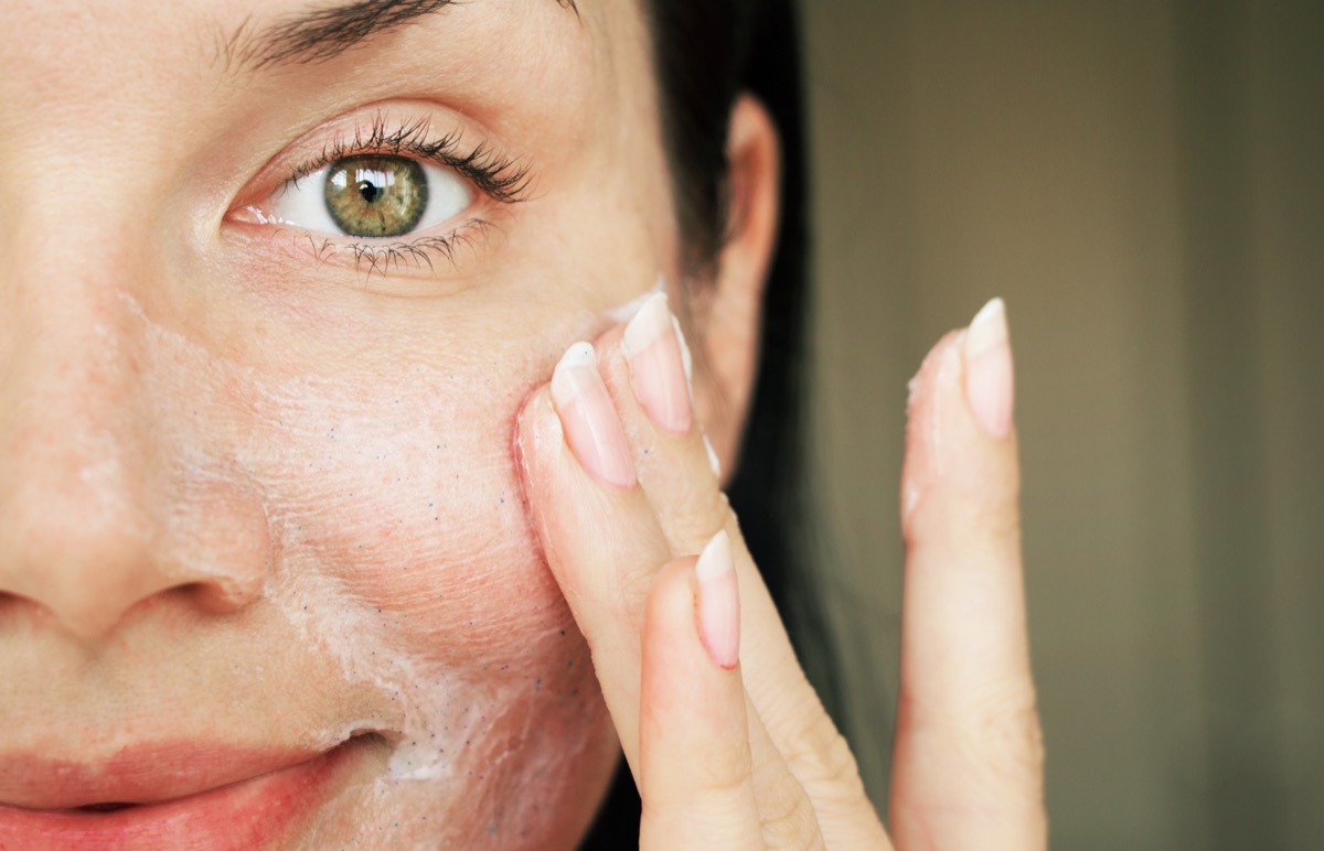 Closeup of woman applying gommage exfoliant
