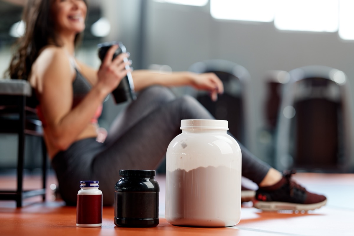 Young woman taking a workout break to enjoy a protein smoothie