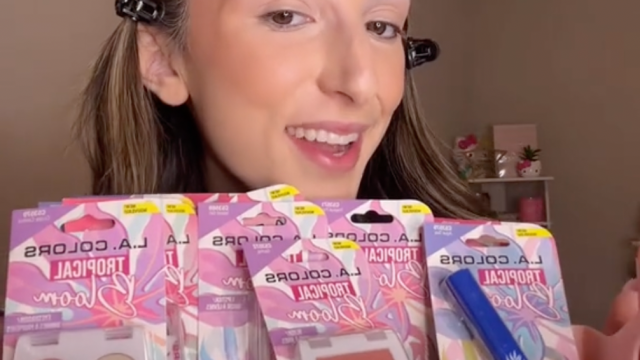 Young woman holding up makeup products from Dollar Tree