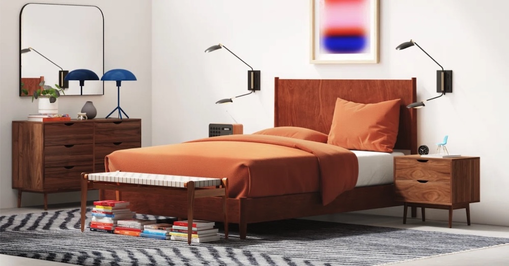 A bedroom set with burnt orange duvet and dark wood nightstands