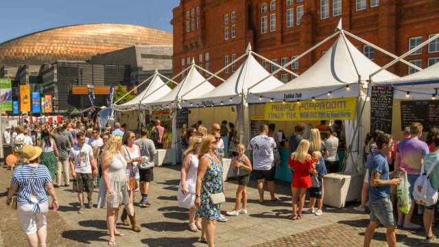 A crowd of people at an outdoor food festival