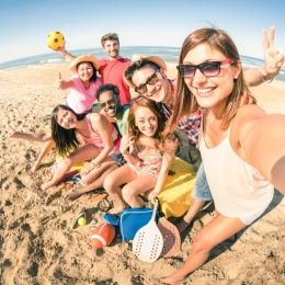 group of friends taking a selfie at the beach