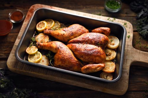 Portuguese butterflied roast chicken in a cooking pan, crapaudine style