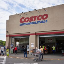 A Costco storefront with shoppers entering an exiting