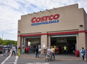 A Costco storefront with shoppers entering an exiting