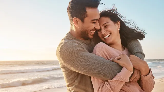 Couple hugging smiling on the beach