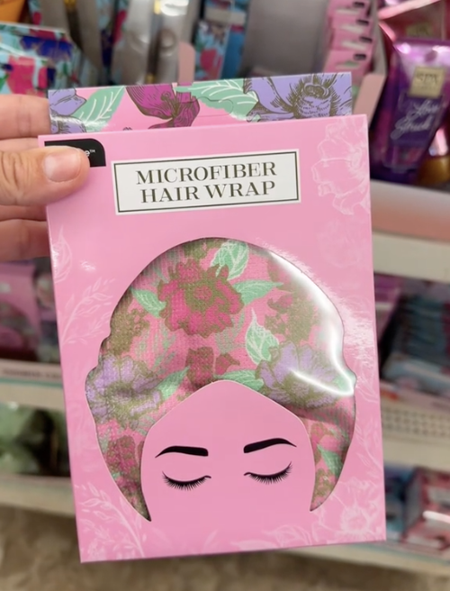 A shopper holds microfiber hair wraps while shopping for the best Mother's Day gifts at Dollar Tree.