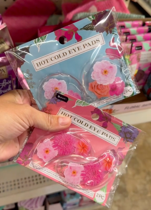 A shopper holds two hot and cold eye pads in Dollar Tree while shopping for the best Mother's Day gifts.