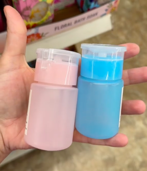 A shopper holds two dupe bottles from Drunk Elephant while shopping for the best Mother's Day gifts at Dollar Tree.