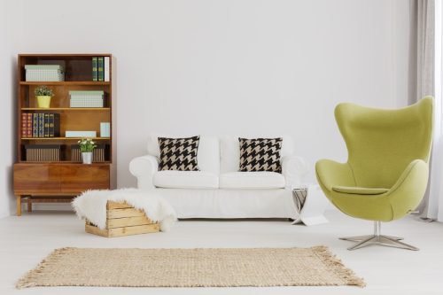 Harmonious and elegant living room decor, with a renovated modernist bookcase and a green egg chair