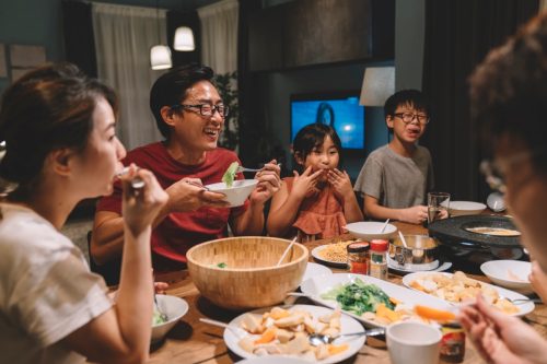 family laughing at dinner table