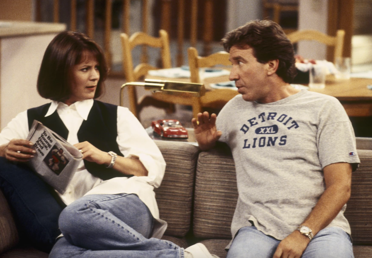 Actors Patricia Richardson and Tim Allen sitting on a couch in an episode of Home Improvement.