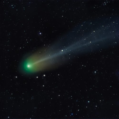 A telescopic photo of Comet 12P/Pons-Brooks with a green aura in the night sky