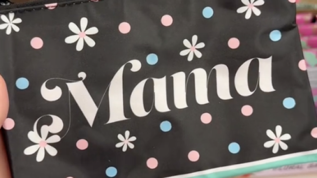 A shopper holds a cosmetic bag that says "mama" while shopping for the best Mother's Day gifts at Dollar Tree.
