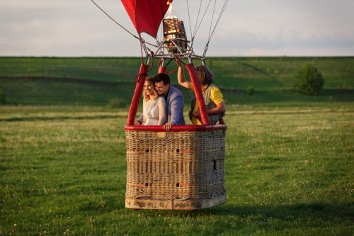 couple in hot air balloon basket