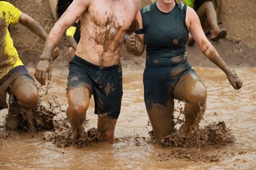 couple competing in tough mudder race