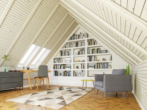 Stylish attic reading nook and office with white painted ceiling and bookshelves