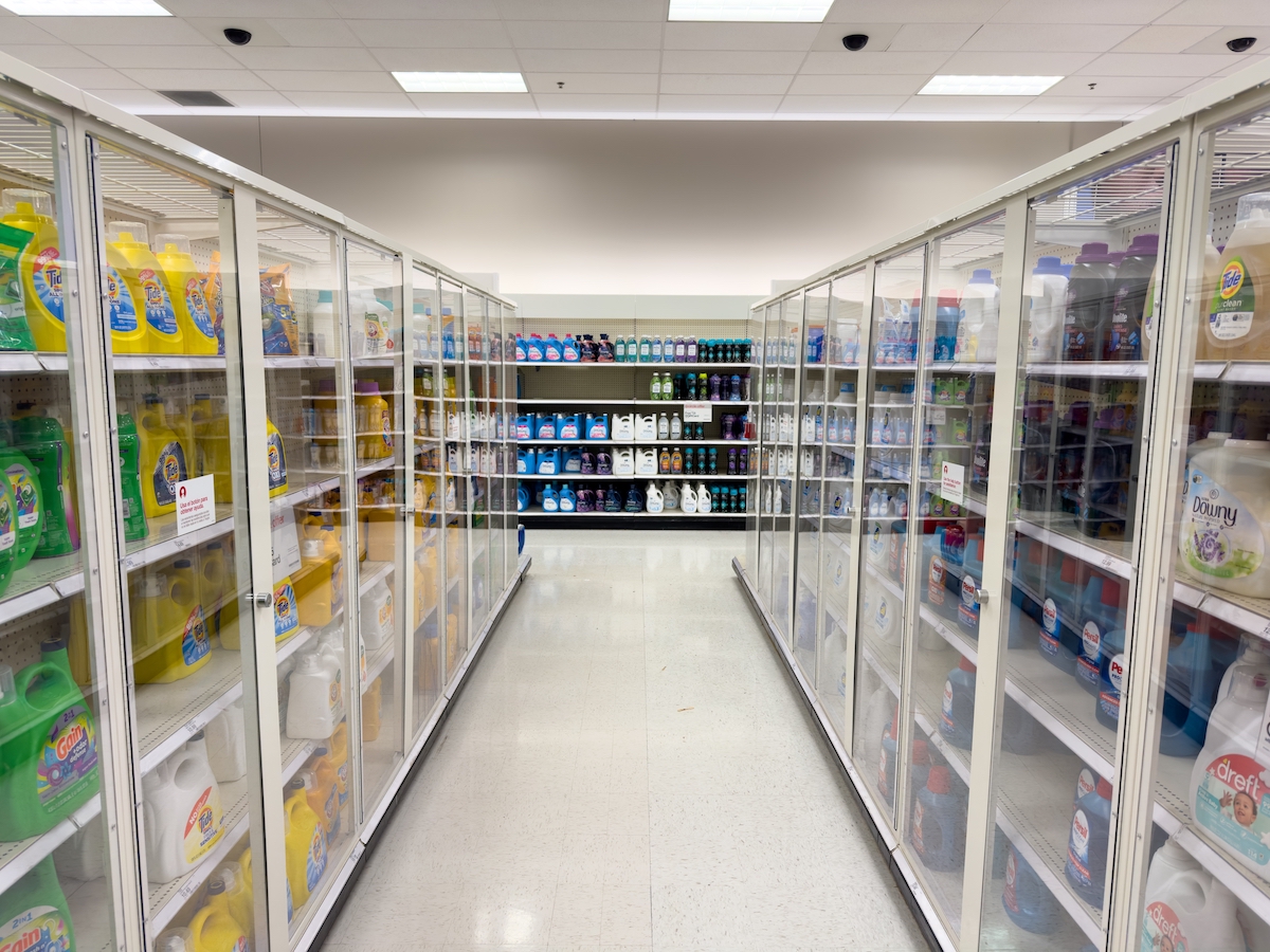 Locked laundry detergent behind glass doors inside a Target store.