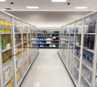 Locked laundry detergent behind glass doors inside a Target store.