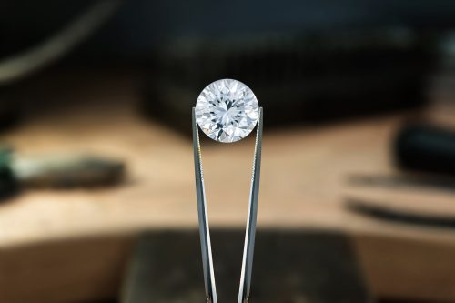 tongs holding a diamond stone