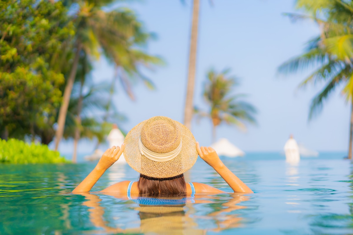Young woman relaxing in a pool on a wellness retreat vacation