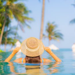 Young woman relaxing in a pool on a wellness retreat vacation