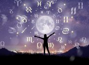 Astrological zodiac signs inside of horoscope circle surrounding the moon in a night sky