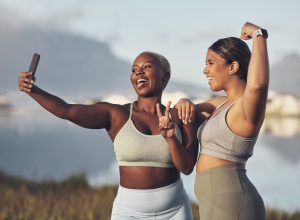 Shot of two women taking a selfie while out for a runt together