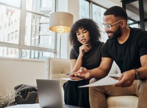 A young couple using a laptop to go over their finances