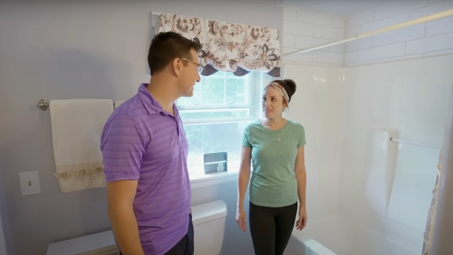 Couple standing in a bathroom on the HGTV show "House Hunters"