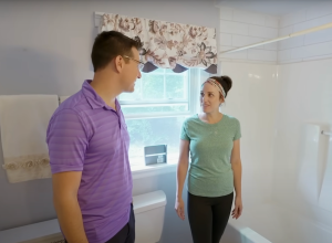 Couple standing in a bathroom on the HGTV show "House Hunters"