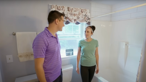 Couple standing in a bathroom on the HGTV show House Hunters