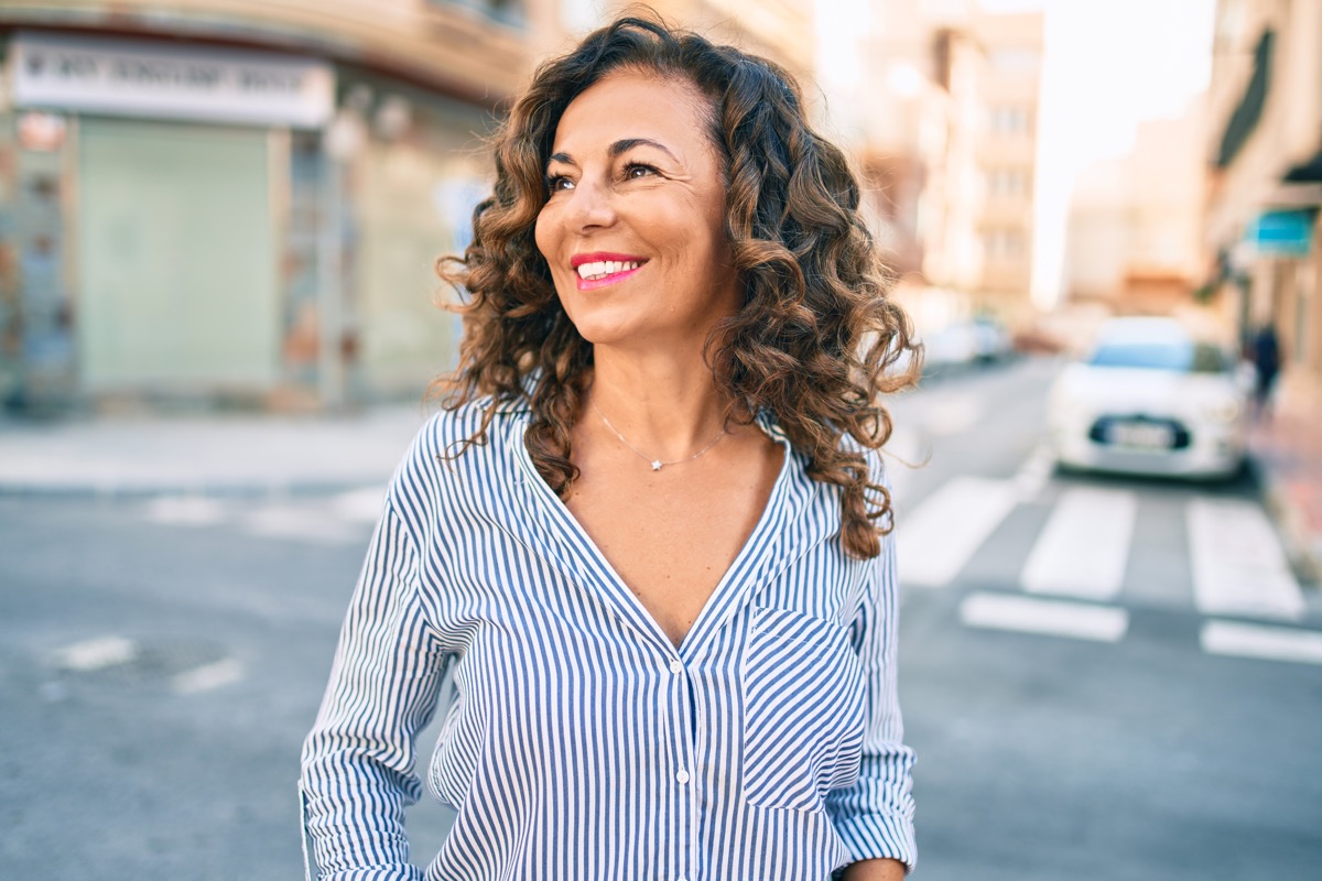 woman looking happy and confident while standing outside