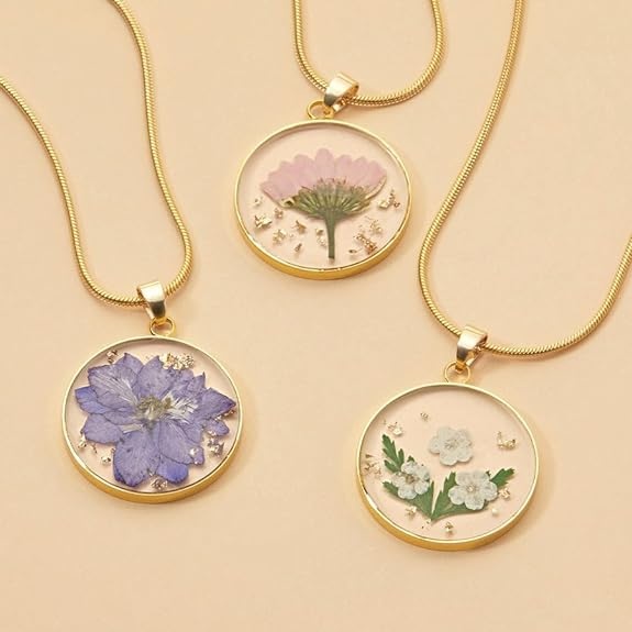 Gold necklaces with pressed flowers in resin