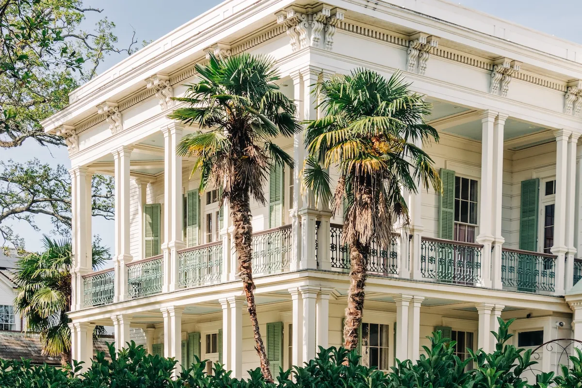 Garden District mansion building facade with palm trees, New Orleans