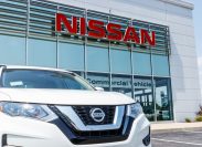 White Nissan car oustide a dealership