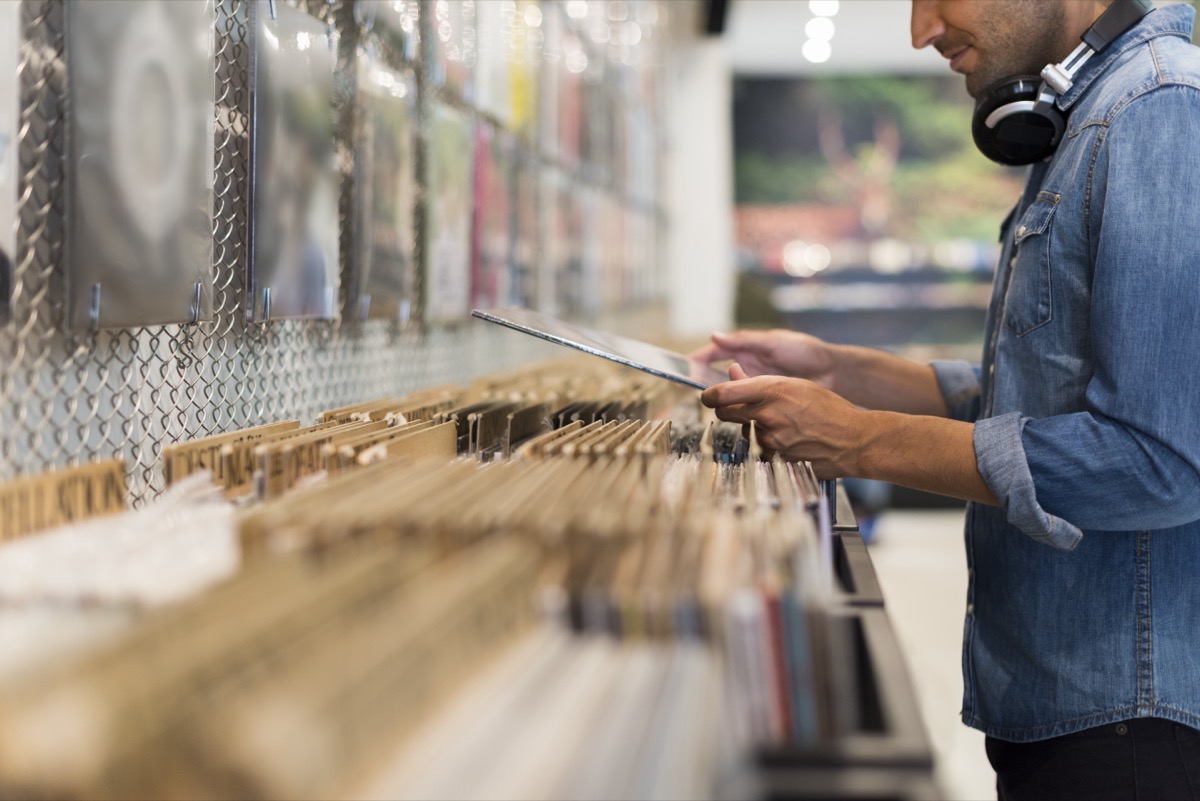Man browsing through shelves at vinyl record store