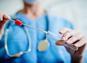 Close up of doctor with sample from sick woman. Selective focus on sample.
