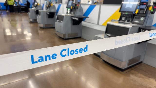 Lane Closed tape in front of Self Checkout registers inside local Walmart Department store.