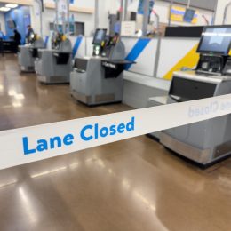 Lane Closed tape in front of Self Checkout registers inside local Walmart Department store.