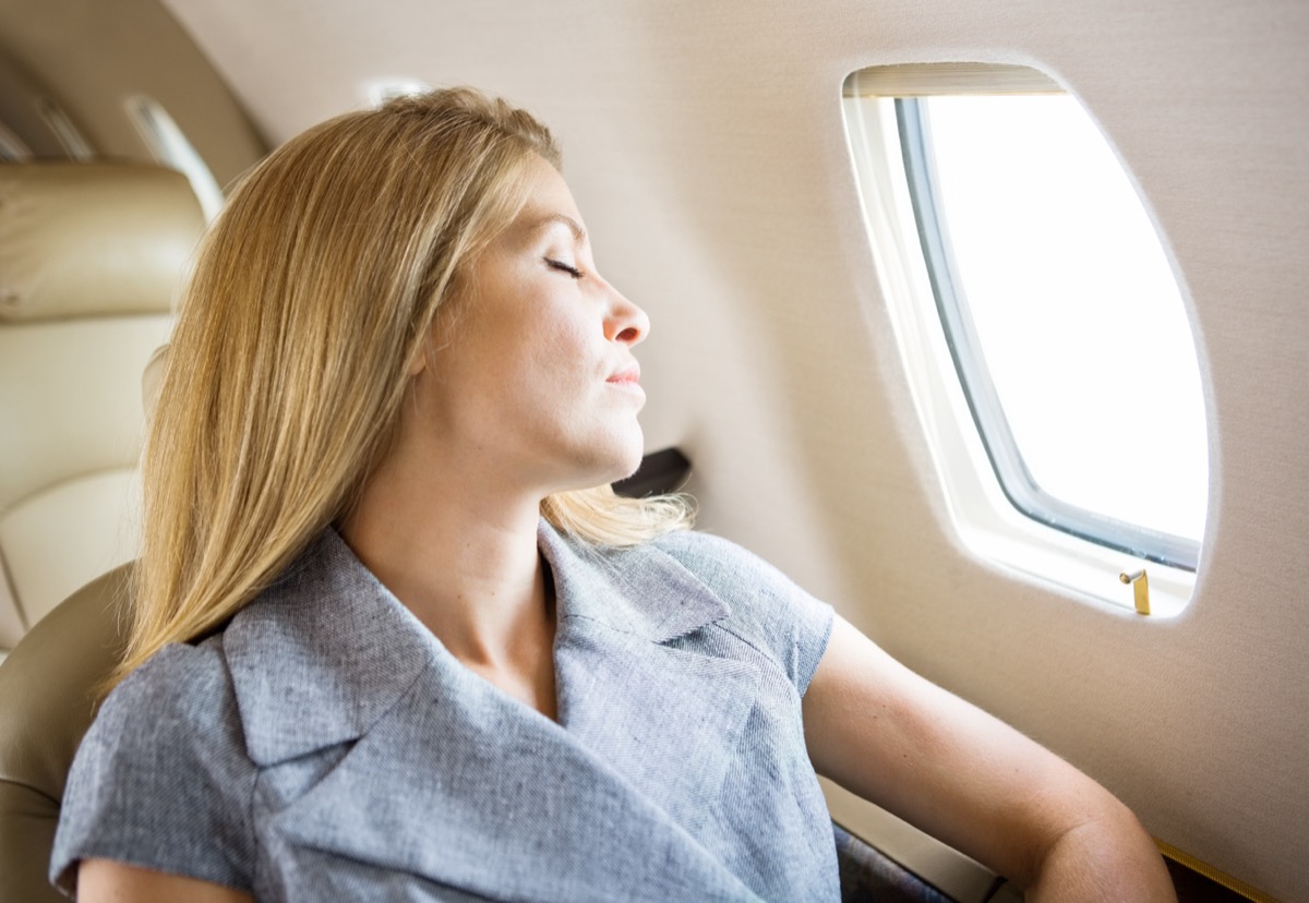 woman sleeping on flight