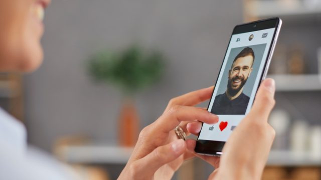Woman swiping on match while using Tinder dating app