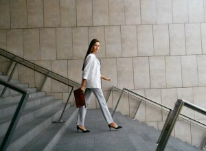 confident professional business woman walking downstairs