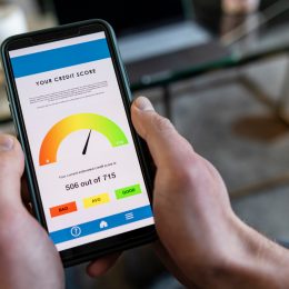 A close up of a smart phone with a person's credit score on it