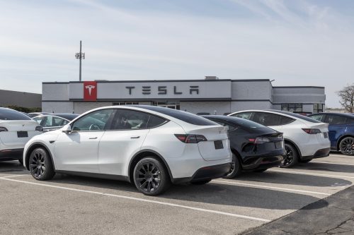 Tesla dealership with cars on display in lot