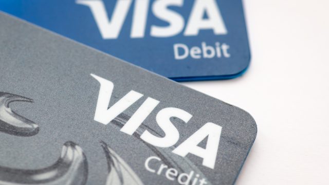 A Visa credit and debit bank card isolated in white.