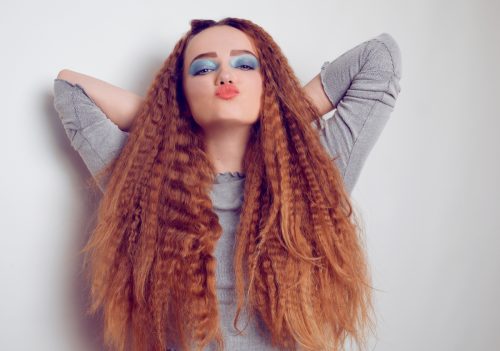 Young woman with voluminous crimped red hair