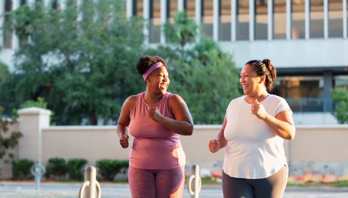 Two women exercising in the city. 